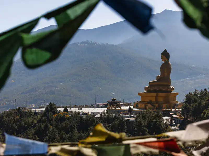 Buddha Dordenma statue framed by prayer flags